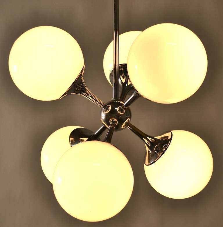 Five white glass ball shades, mount on a bright chrome fixture. Diminutive scale makes this perfect for a foyer, hallway, or small space.
Total Dia 12' each ball shade 5