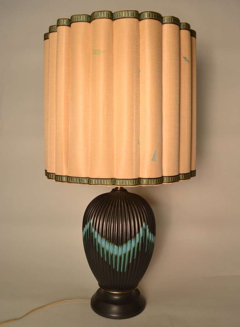 Drip glaze fluted ceramic body, original shade and finial. Gun metal ground with turquoise drip decoration. Working condition.