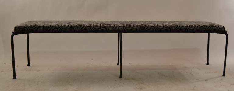 Long six leg bench with square iron frame, and legs. Upholstered seat cushion top.