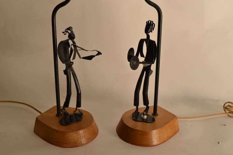 Whimsical and stylish hand made sculpted metal table lamps. One depicts a Cymbal player, the other a Violin player. Both lamps are in fine original condition, with the exception of one switch (cymbal player) that has been replaced. The shades shown