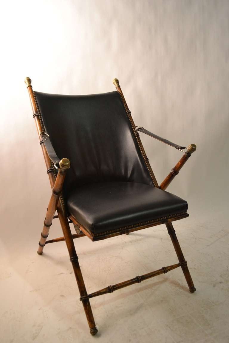 Pair Campaign chairs made in Italy for La Barge. Faux bamboo oak frames, leather strap arm rests, vinyl seat and back.