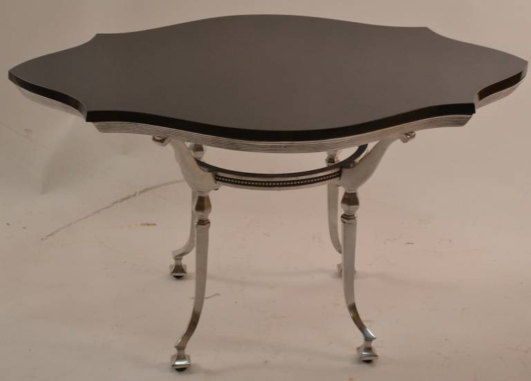Cast aluminum base with polished stone top. Elegant and graceful perfect small cocktail, coffee, or occasional table.