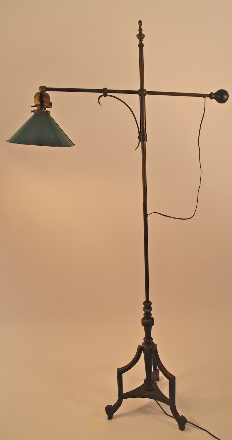 Industrial, adjustable floor lamp. Painted,  iron rod construction with green metal shade. The horizontal arm will extend in and out to position the light, and will adjust up and down to desired height ( 46