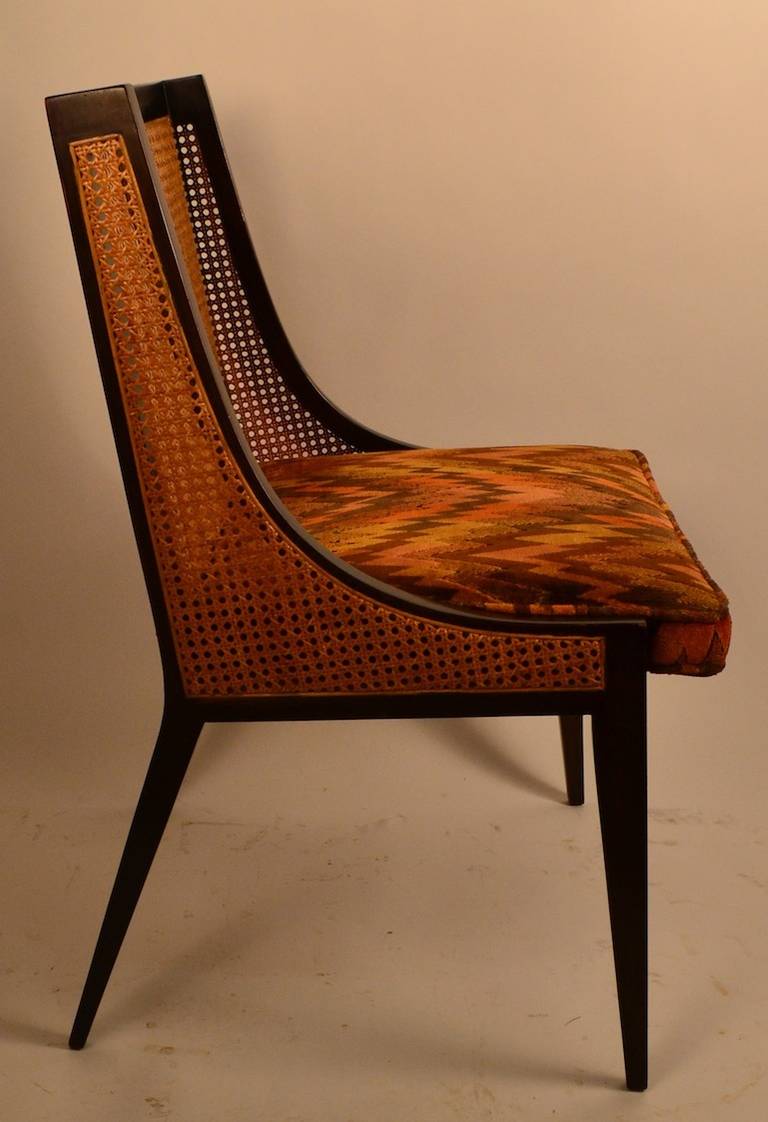 Mahogany frames, caned back, and sides, original Jack Lenor Larsen fabric seats. Eight matching chairs selling as one lot.