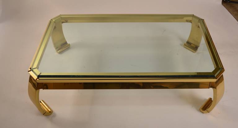 Solid brass base in the Chinese manor, with plate glass top. This table is marked 