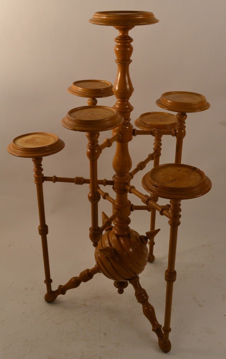 Architectural turned wood, ball, and spike construction, period 19th C. Late Victorian, Aesthetic Movement plant stand, with some Gothic influence as well. 7 platforms each independently supported by a  turned wood arm. The stand is currently in