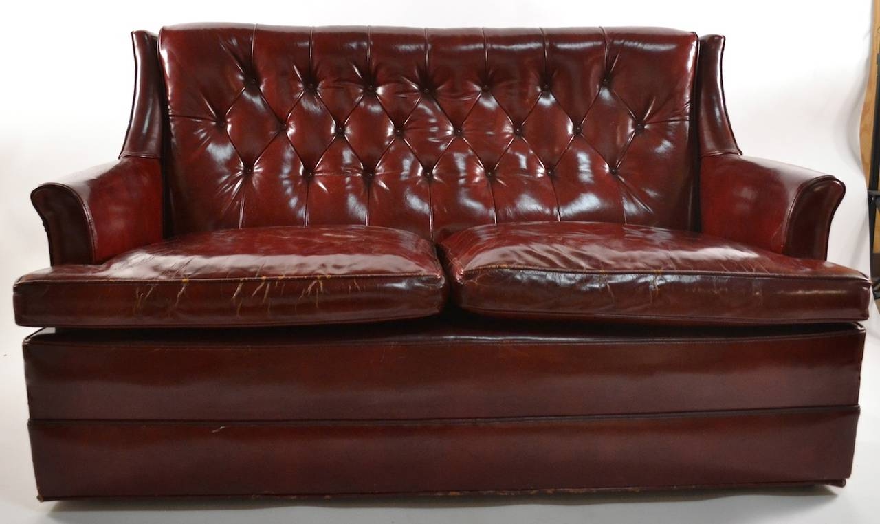 Wonderful aged patina, unusual size and form. Two seat, Loveseat size sofa, great quality, very fine original condition ( minor loss to bottom edge as pictured ) . English style, probably American made, couch has two loose cushions, and frame rests