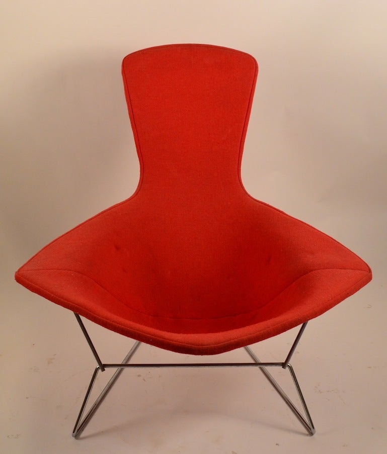 Nice vintage example of the iconic Bertoia design chair. Original orange fabric cover ( slightly crunchy ) Chrome frame, bumpers and chair in very fine condition.