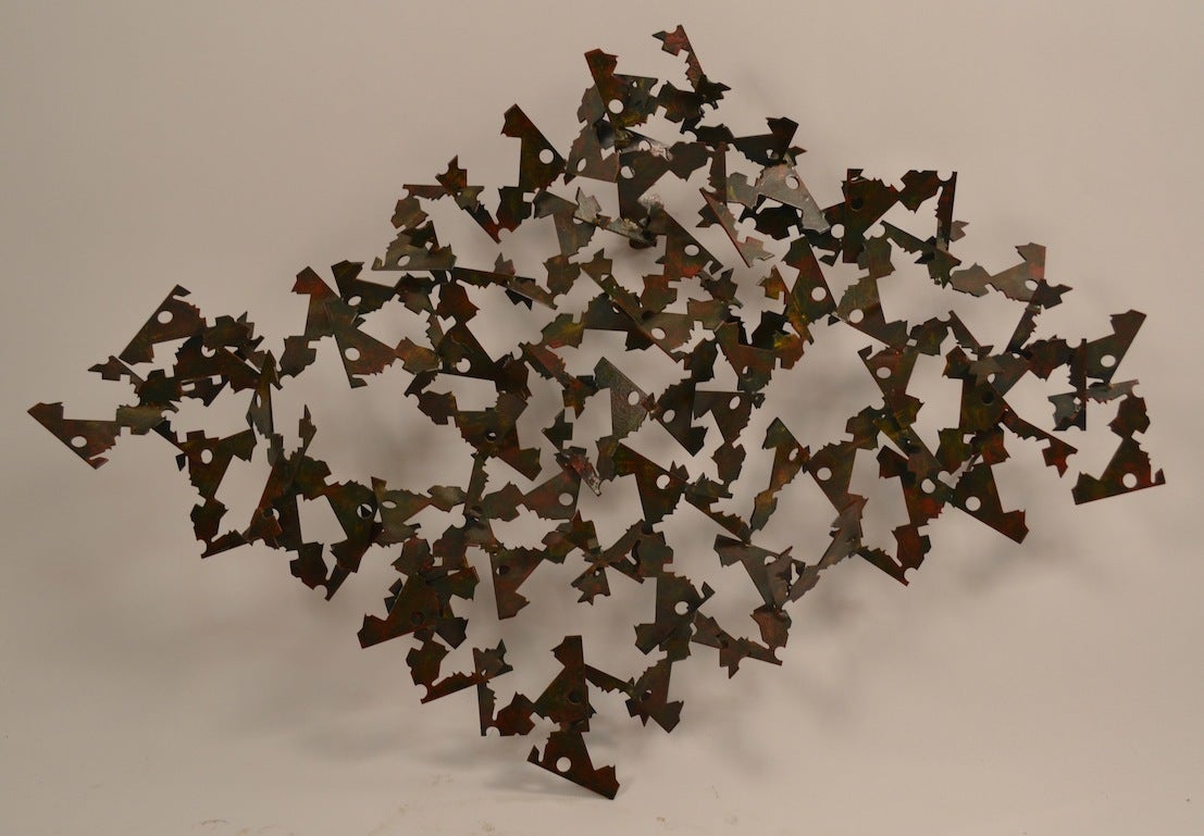 Interesting polychrome iron Brutalist wall mount sculpture. Of diamond form, welded metal abstract forms constitute a large diamond shaped sculpture. Unusual original  paint decorated surface.