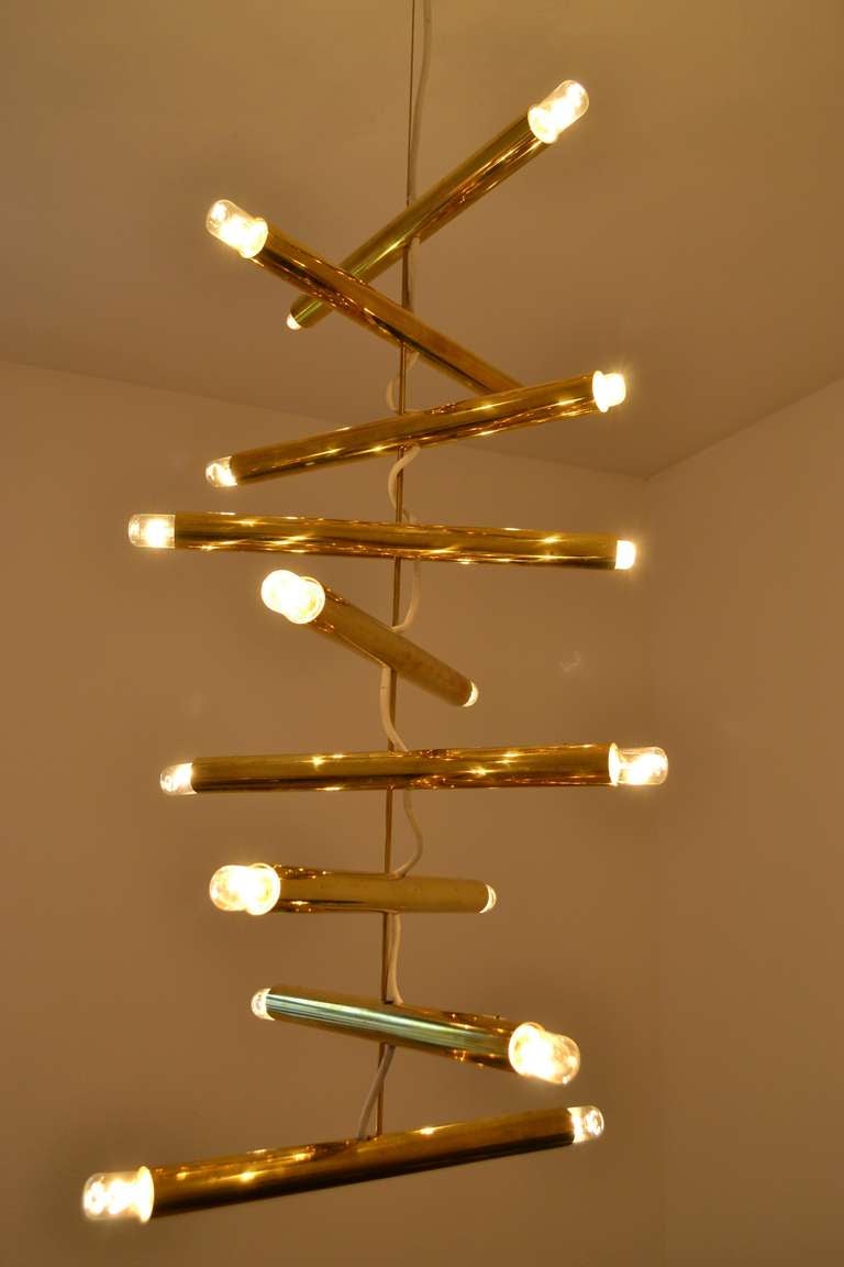 Rare and chic pair of ceiling/ chandelier by Giampiero Aloi manufactured by Lumi Milano, circa 1970. Each brass tube can rotated on itself at 360° for created an unique atmosphere, please see pictures for example. The high is also adjustable. Light