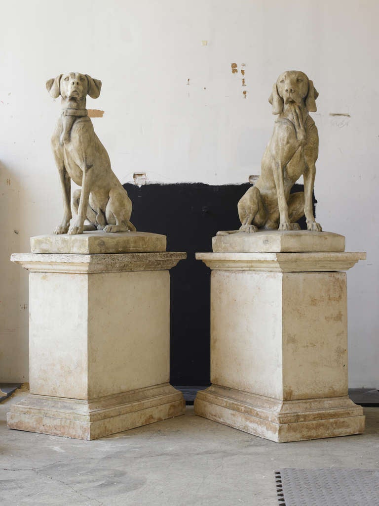 Pair of sculpted dogs in the style of French sculptor Andre Jacquemart in composition stone with custom faux finish.