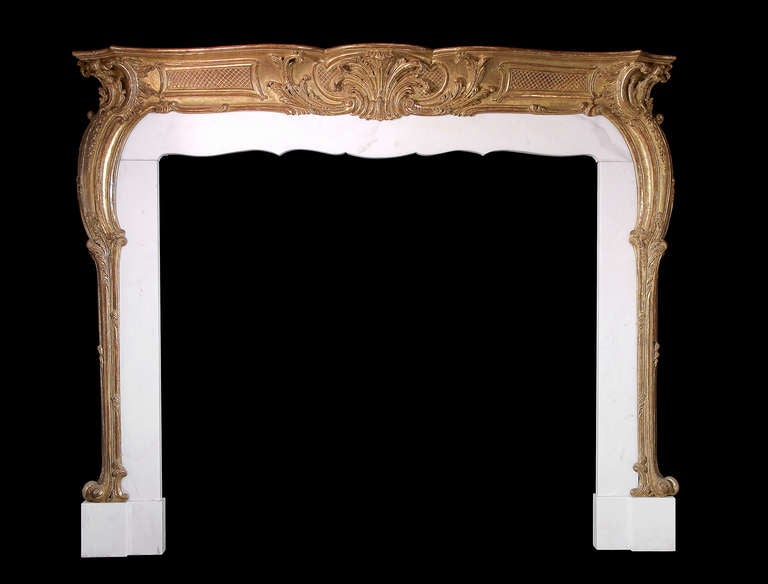 An 18th century beautifully carved and gilded pine mantel. Opening dimensions: 59.25