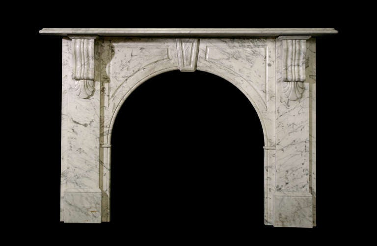 Victorian arched mantel with keystone in Carrara marble with fielded flanking panels (VIC-W60). Opening dimensions: 29