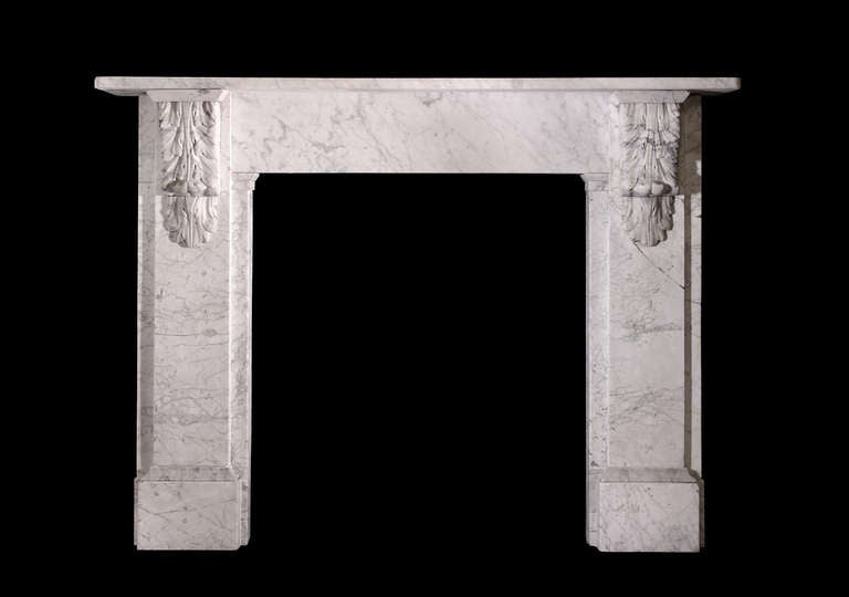 An attractive mid-19th century mantel in veined Carrara with well carved “feathered” corbels, plain jambs and frieze. Measures: 34 3/4