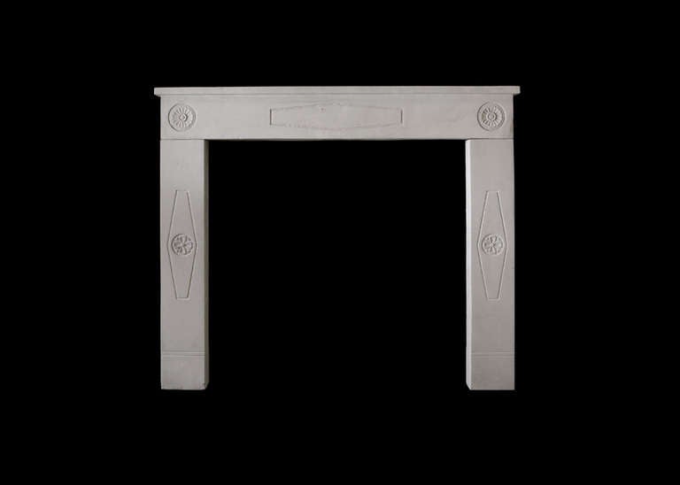An unusual early 20th century French limestone mantel from the Marseilles area, with carved rosettes and fielded panels. Opening dimensions: 37.25