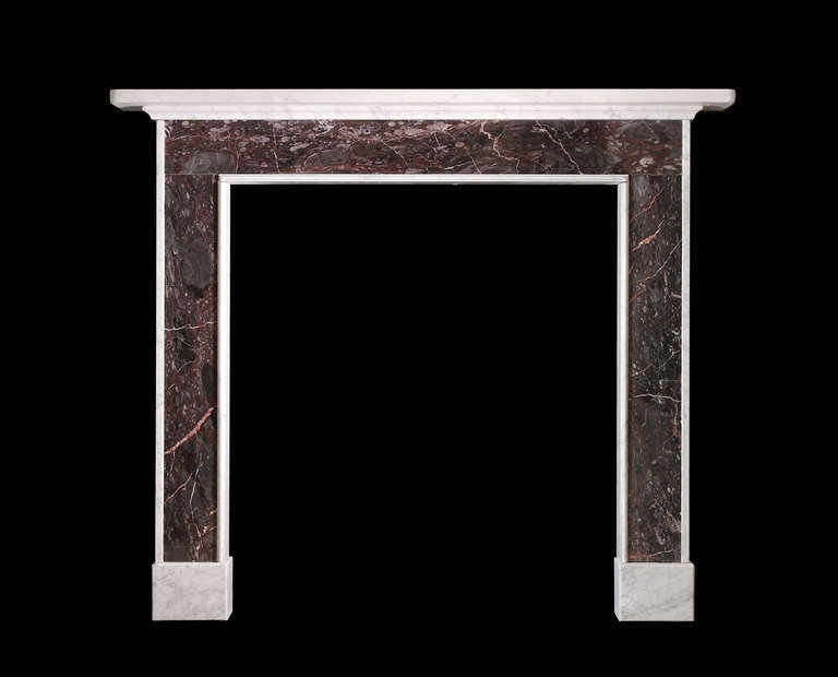 A Regency period chimneypiece of architectural form in Carrara marble with Ashburton marble panels in the jambs and frieze.
Opening Dimensions 37 1/2