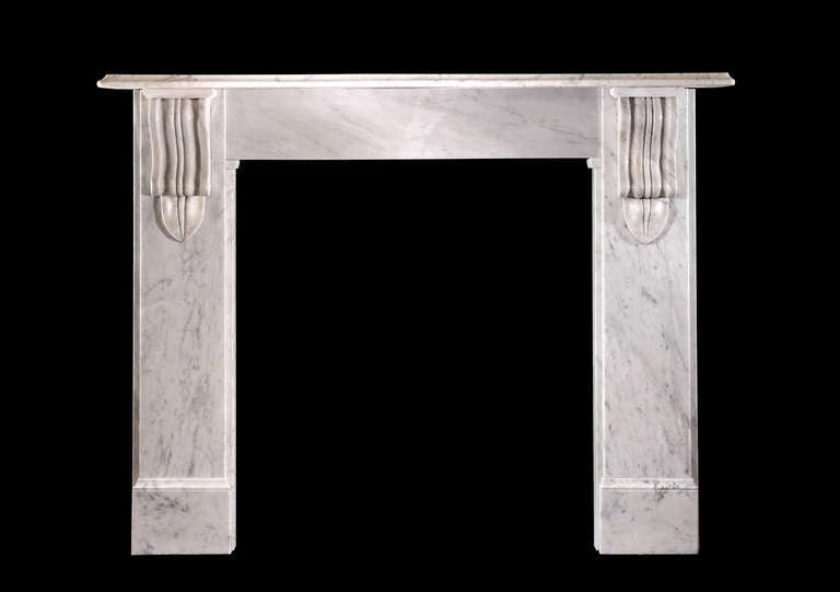 A late Victorian Carrara marble surround with plain jambs and frieze, the former headed by moulded corbels supporting a generous mantel shelf with a bevelled edge.

Opening dimensions: 35 3/4