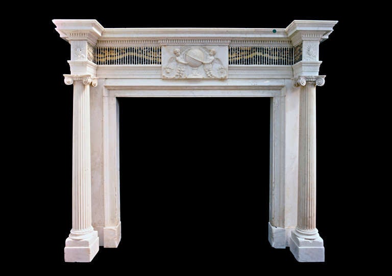 Late 18th century statuary marble mantel with detached fluted columns terminating in ionic capitals beneath corner blockings carved with anthemions. Bearing many hallmarks of the work of Robert Adam. Opening dimensions: 48.5