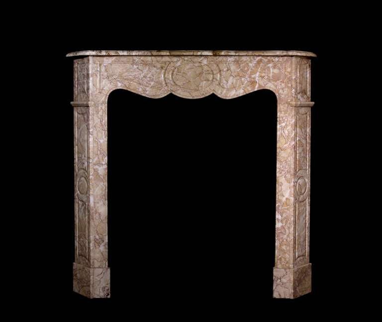 A 19th century French pompadour style mantel in crema Valencia marble. Opening dimensions: 26.5