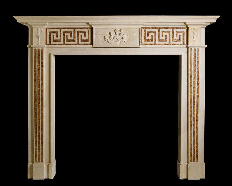 A good late 18th century English mantel in statuary marble with Greek Key frieze panels inlaid with Spanish Brocatella and flutes of the same inlaid to the pilasters. Opening dimensions: 48.5