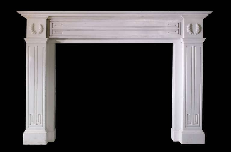 Early 19th century Irish mantel in statuary marble in the manner of John Soane. The mantel has Greek key motifs incised into both jambs and the frieze panel. The former terminate beneath mouldings surmounted by corner blocks carved with garlands.