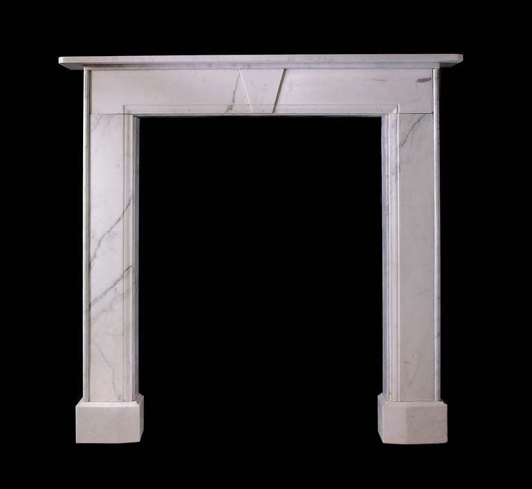 A simple 19th century mantel in statuary white marble with keystone in the center of the frieze. Opening dimensions: 31" W x 42.5" H.