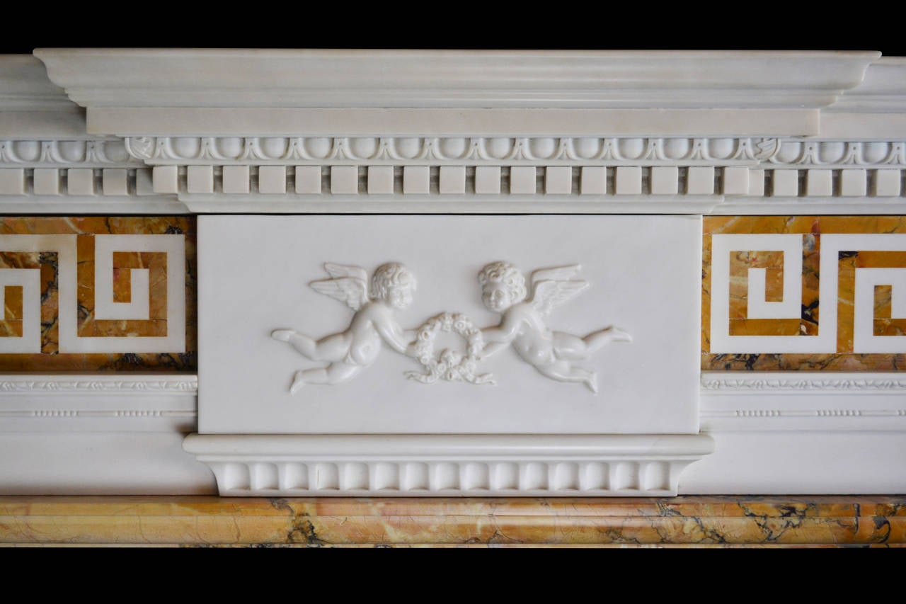 A handsome mid-19th century marble mantel in Italian statuary and convent Siena marbles with detached Siena columns terminating in finely carved ionic capitals beneath Siena corner bocks decorated with crisply carved rosettes.

Opening dimensions: