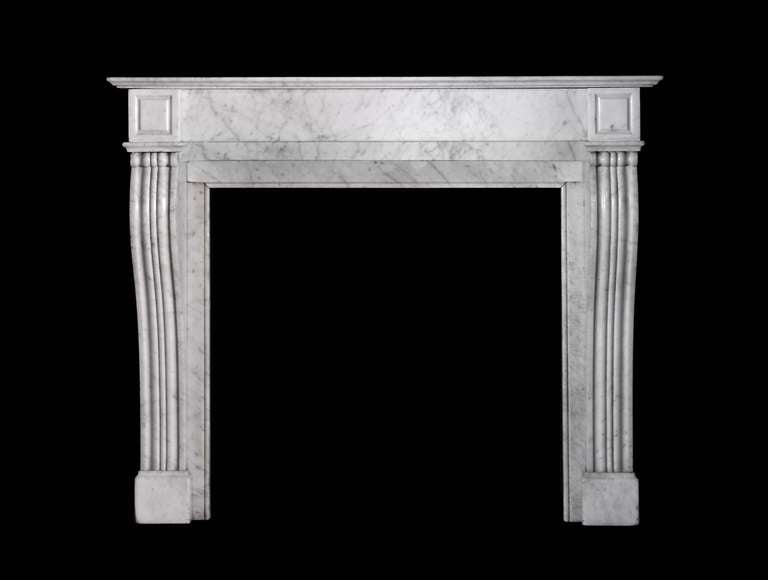 A 19th century Louis XVI style mantel with console jambs in Carrara marble. Opening dimensions: 30.75