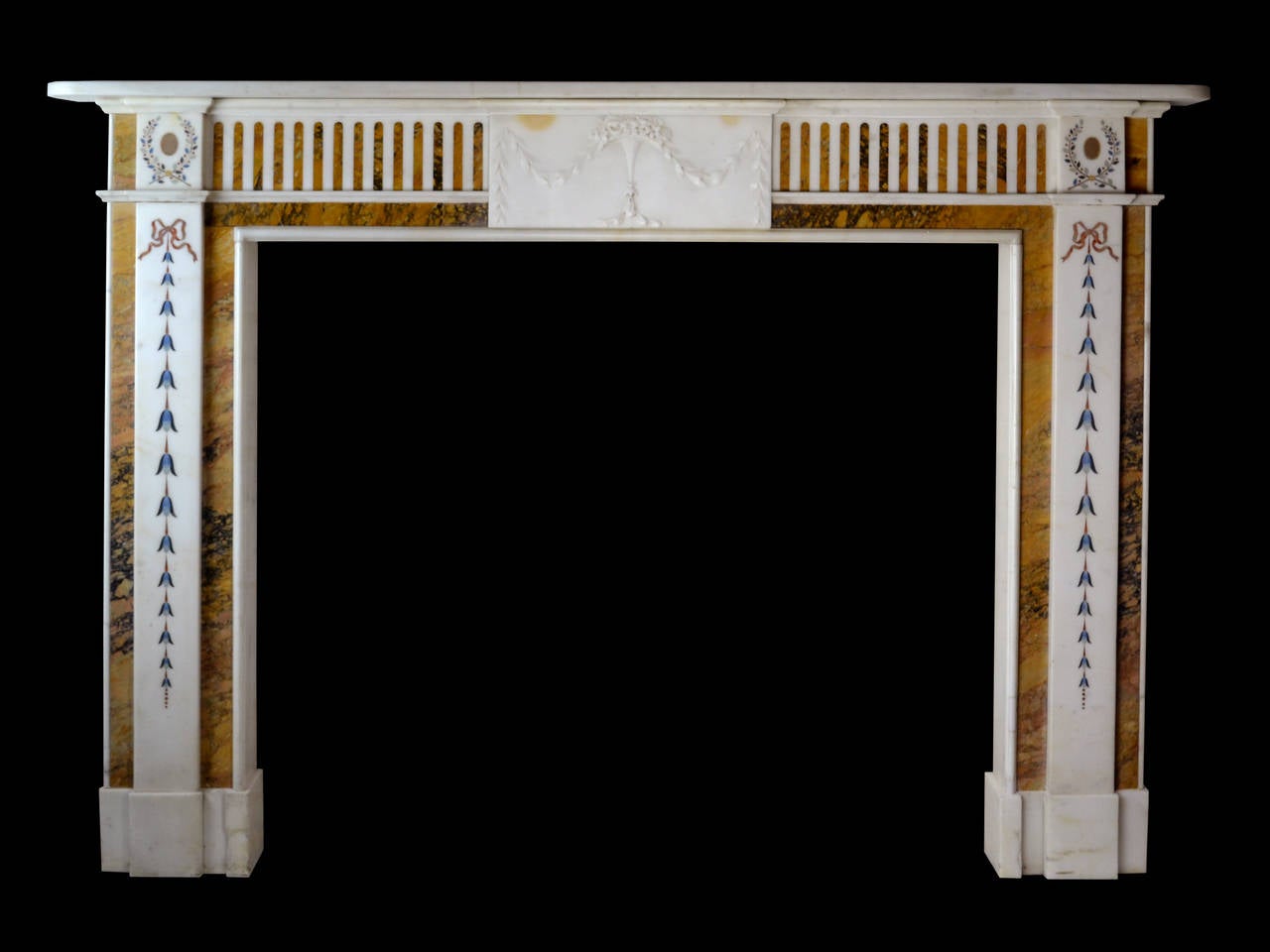 An attractive and decorative late 18th century Irish chimneypiece in statuary marble with richly colored and figured convent Siena marble flanking the pilasters and framing the aperture.

Opening dimension: 46 1/2