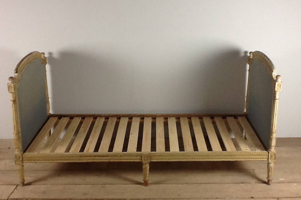 A beautiful French, circa 1890-1910 single bed in original paint and fabric. The patina on this bed is exceptional. A new slatted wooden base has been added. The height to the wooden slats is 10.25