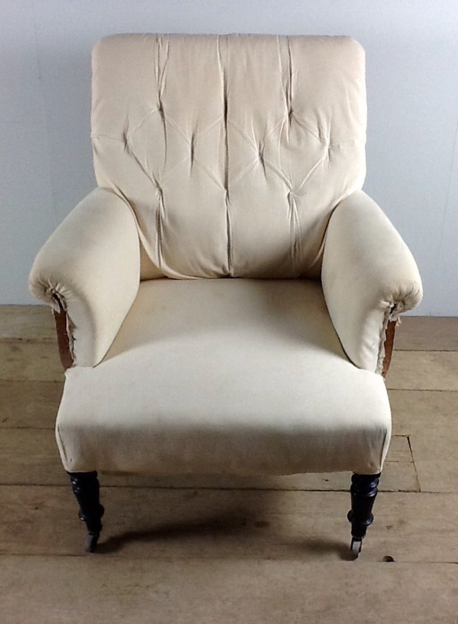 A handsome French Napoleon III period (Louis-Napoleon Bonaparte) button-back armchair in original condition with ebonized turned legs on casters.