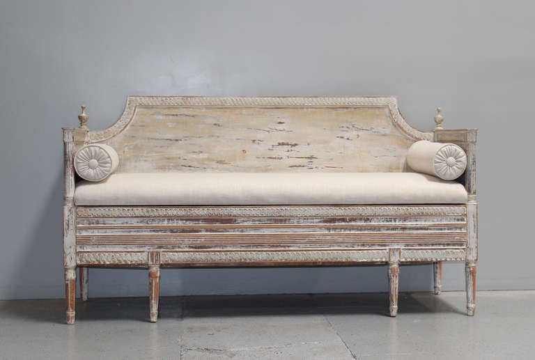 This stunning 19th century Swedish Gustavian settee was found in the Provence region of France. It has carved sheaf of grain finials, the emblem of the Royal House of Vasa, and a reeded seat rail. It has been hand-scraped to reveal the original