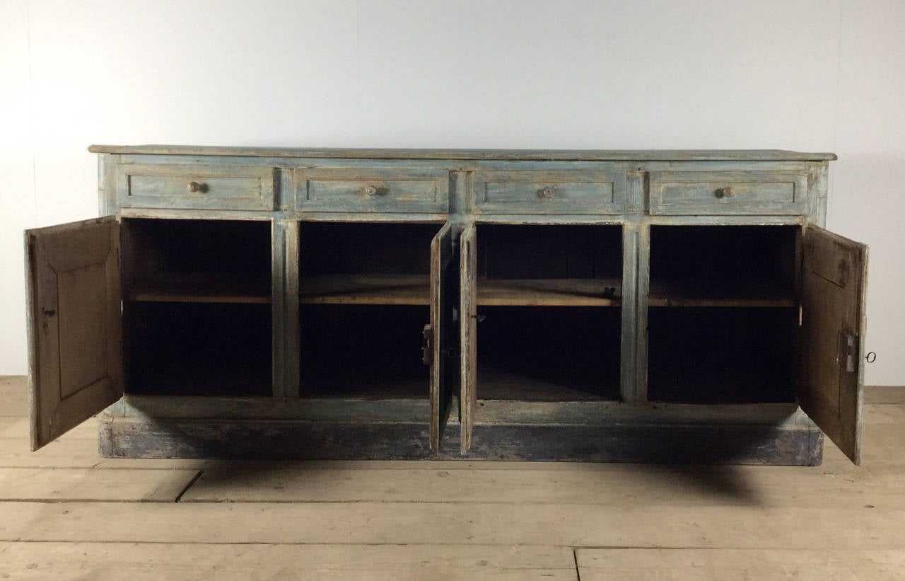 A beautiful French Louis XVI four-door oak buffet with four drawers in old paint with working locks and keys. There is a small old repair to the top that can be restored, if requested.