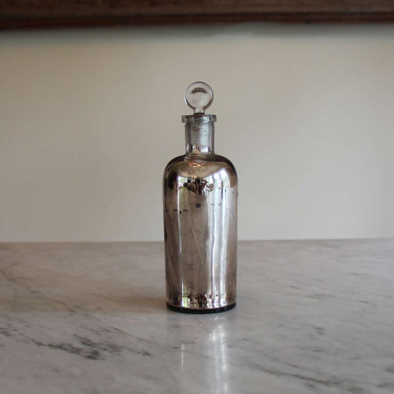 Please ask about group pricing.

Extremely rare 19th century French mercury glass apothecary bottle with glass stopper.  This is perhaps the most exciting purchase we've made in Provence. Authentic antique mercury glass is becoming more difficult