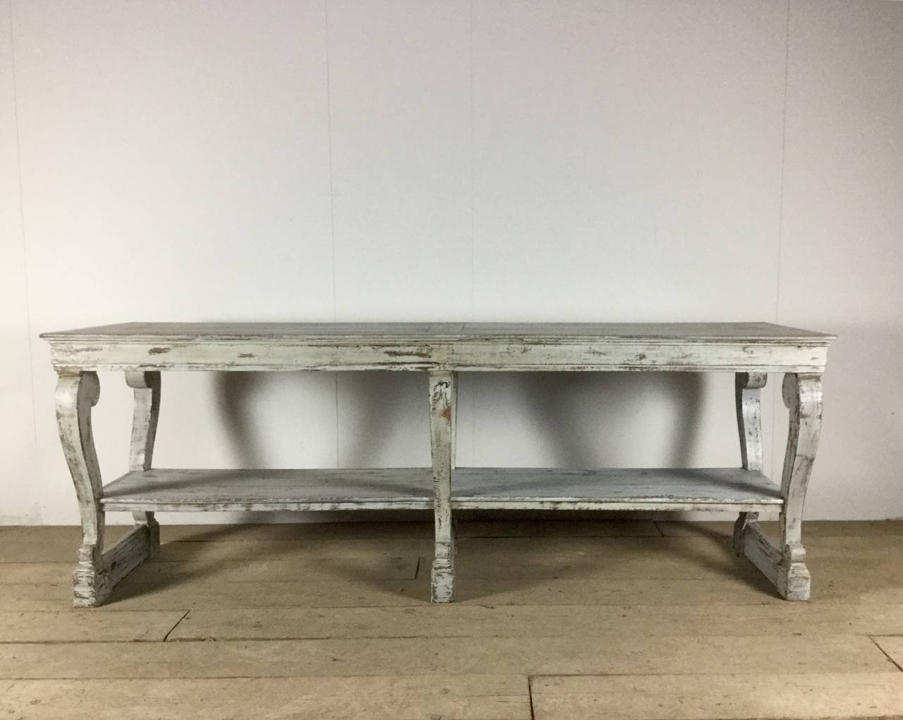 An exceptional painted oak French Charles X draper's table from the Restauration period with parquet tops, three drawers and decorative volute details.  The table's color is a pale dove gray with some of the natural wood peaking through in areas.