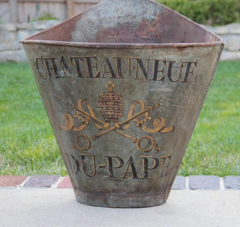 Sold separately.  One available (shown in image 1 & 2).  

Late 19th to early 20th century French grape hods (used for picking grapes). These beautiful French zinc grape hods feature the famous French vineyard, Chateauneuf du Pape and its coat of