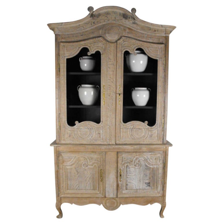 An impressive French, bleached oak vitrine  with original glaze (glass).  This piece has elegant proportions and a lovely charcoal black painted interior.  The upper section has two shelves and lower section has one shelf.  Circa 1890.