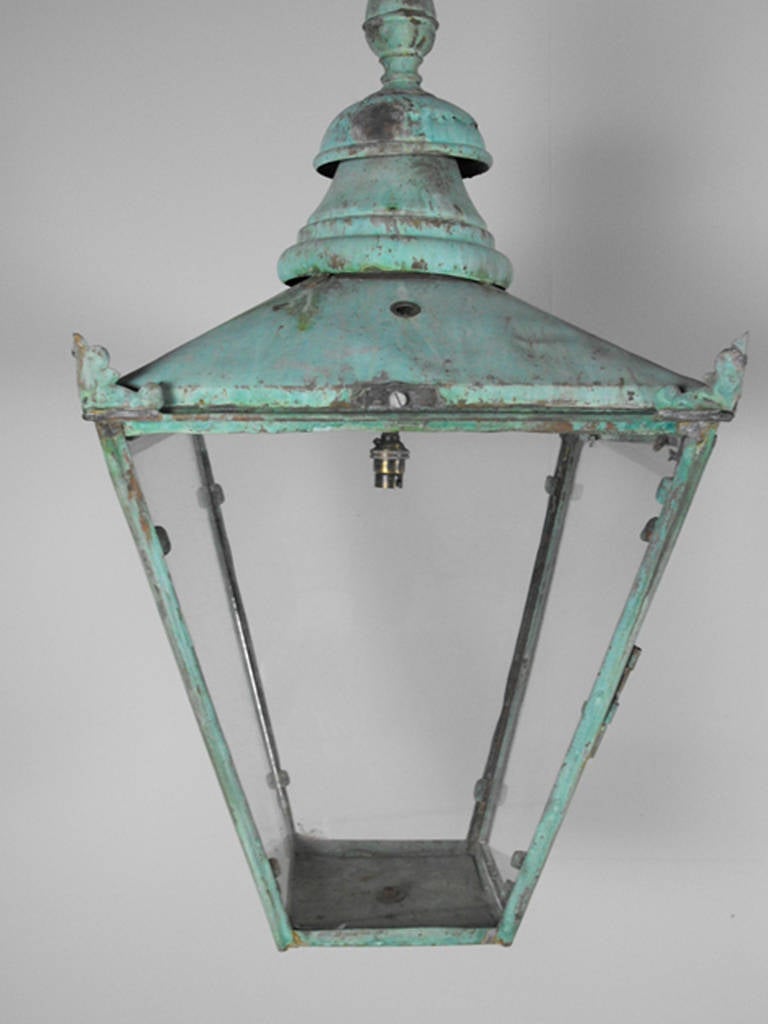 A wonderful early 20th century English glazed coach lantern that has been weathered to a stunning verdigris color.  It has been rewired for European electrical currant, but can be easily converted for use in the U.S.  Circa 1920.