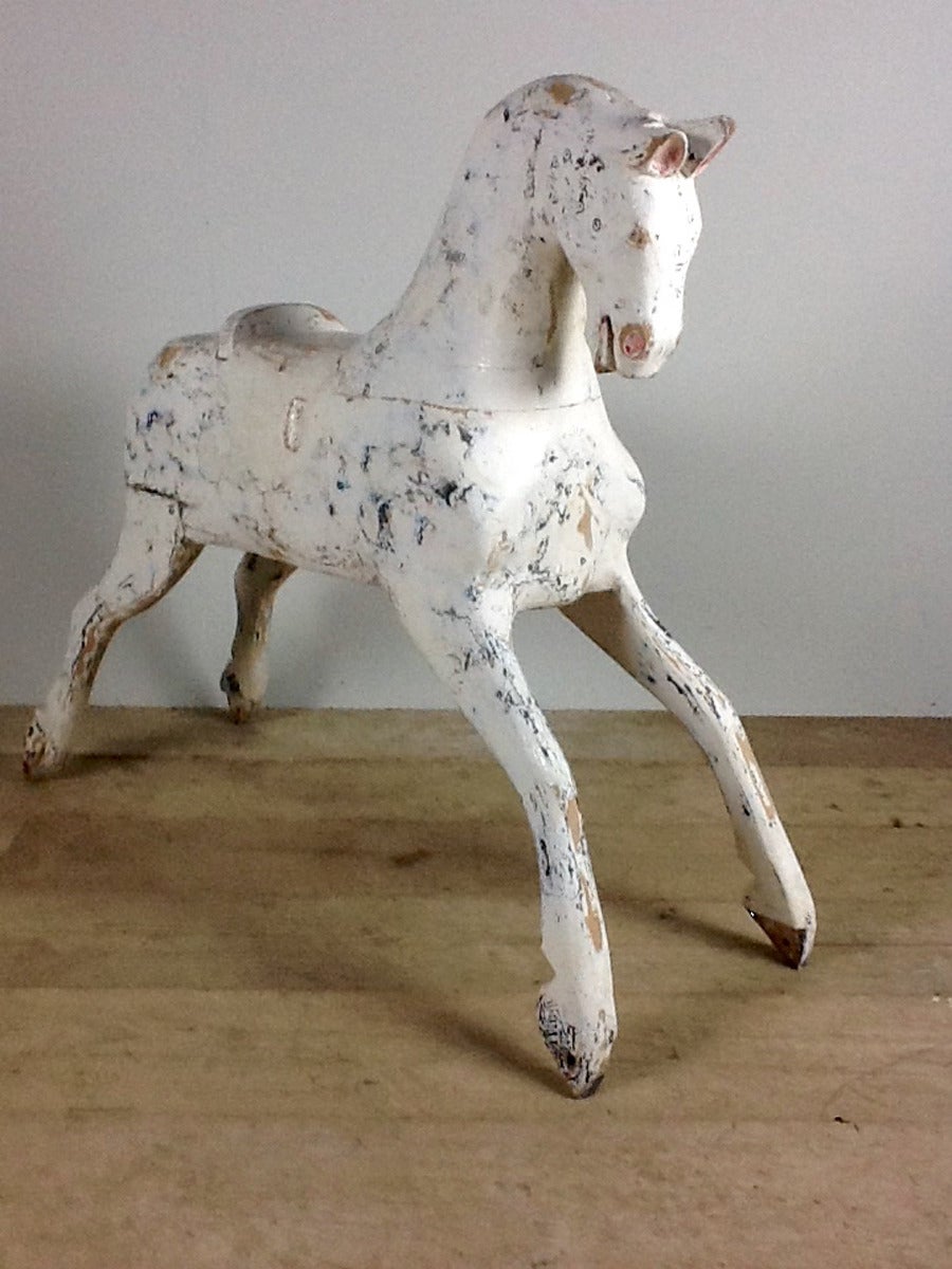 A stunning English painted rocking horse fragment made of wood with elongated legs which stands upright on its own.