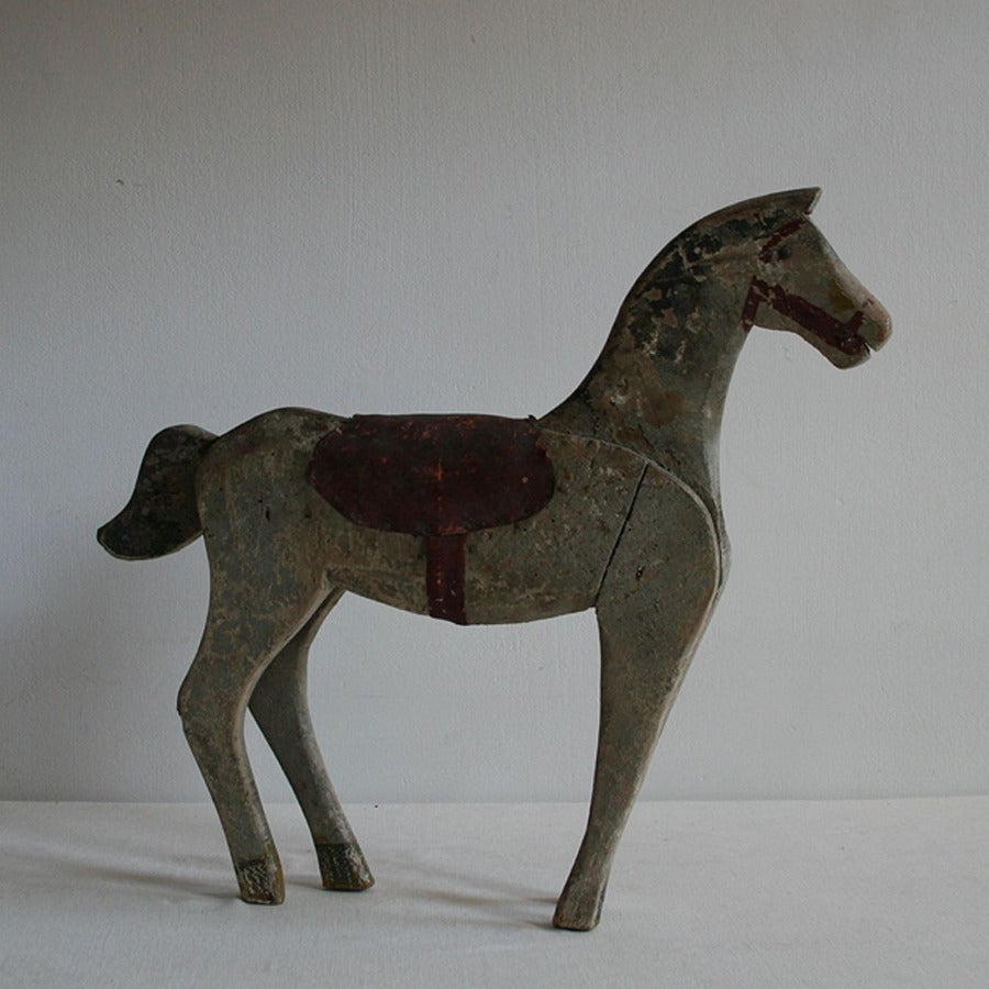 A small French horse carved from wood in original paint, circa 1900.