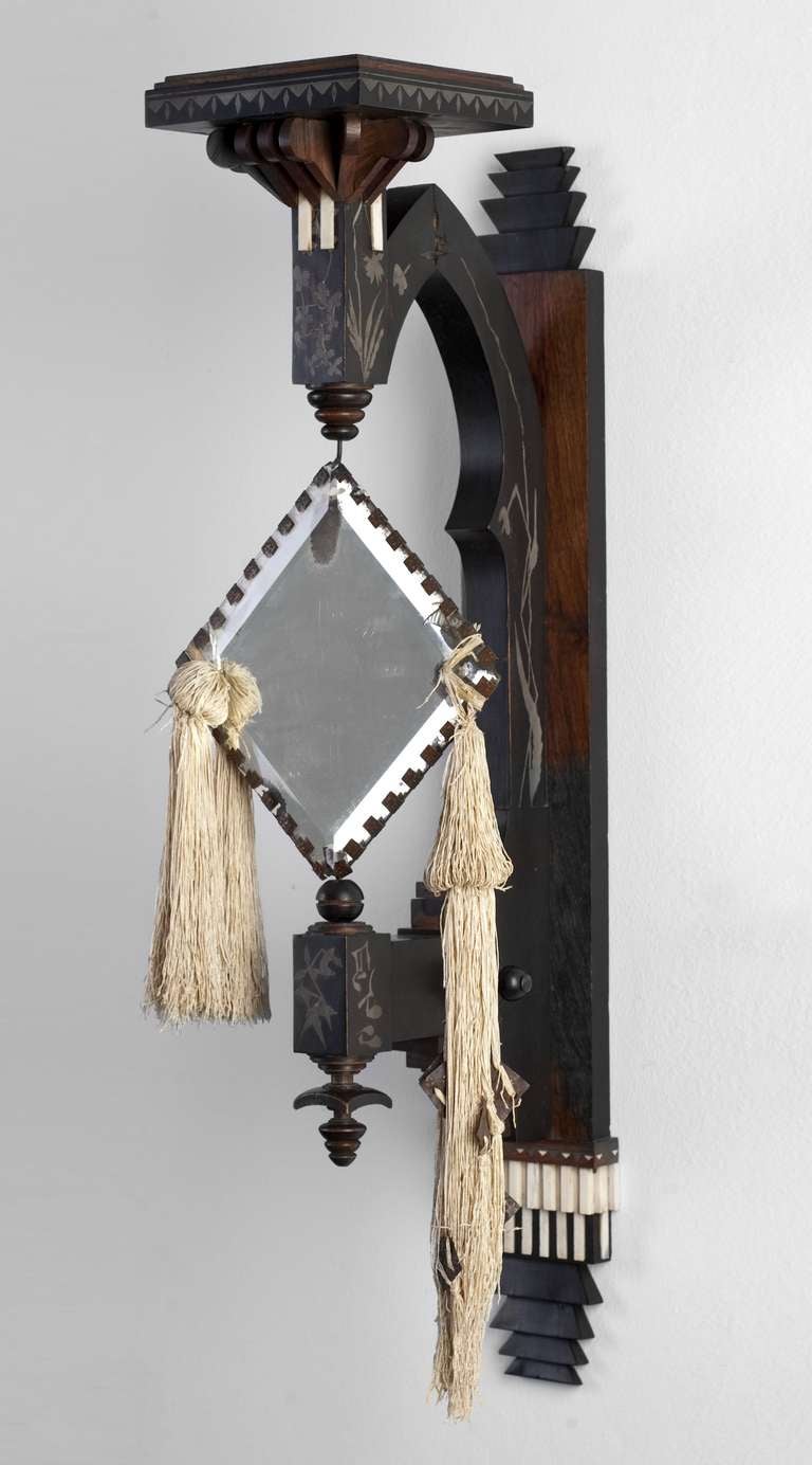 CARLO BUGATTI
Milan 1856 – 1940 Molsheim

MIRROR

designed and executed by: Carlo Bugatti, Milan, around 1900

walnut, partially ebonized and polished, applications in copper and bone, inlay in pewter, original cut and facetted mirror, some