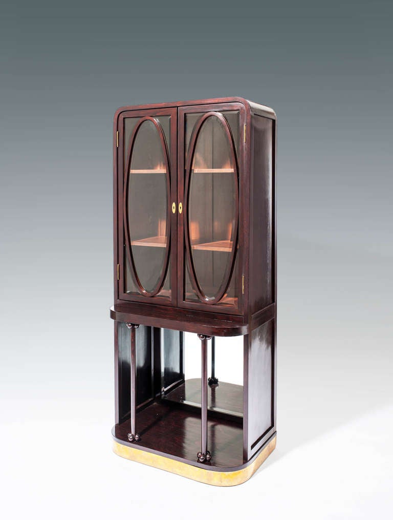 GUSTAV SIEGEL
J. & J. KOHN

designed by: Gustav Siegel, Vienna, 1906
executed by: J. & J. Kohn, model no. 600/7

bent beech and plywood, dyed to mahogany, inside the showcase mahogany veneer, brass fittings, cut and facetted glasses and