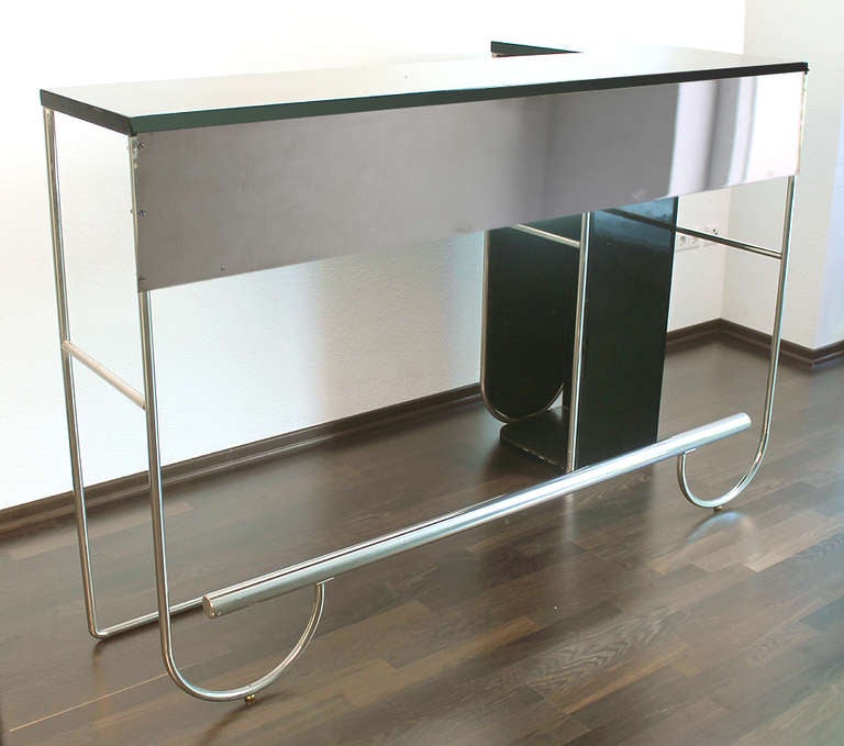 Extremely rare bar counter manufactured around 1930 in Germany, pure bauhaus style with tubular frame.A previous owner added the shelved cabinet on the right hand side and the front nickel plated panel.

Condition: the bar has signs of age such as: