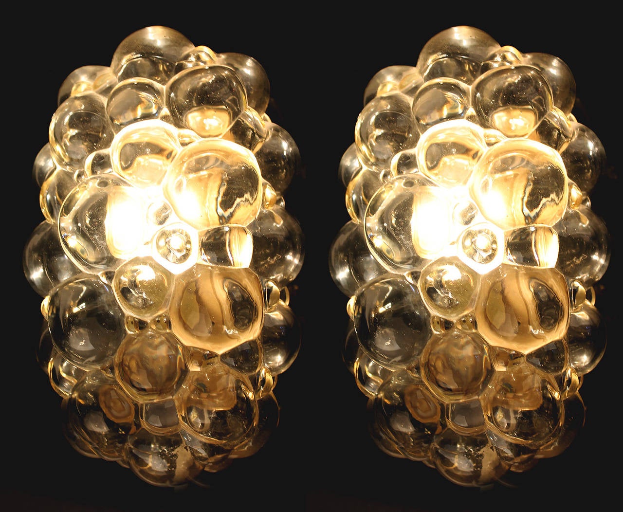 Pair of Bubble Flush Mount Light / Sconce by Limburg, Design by Helena Tynell, made of very thick, glossy bubble shaped glass, glass has slight amber color

1 candelabra size bulb up to 40 watts each