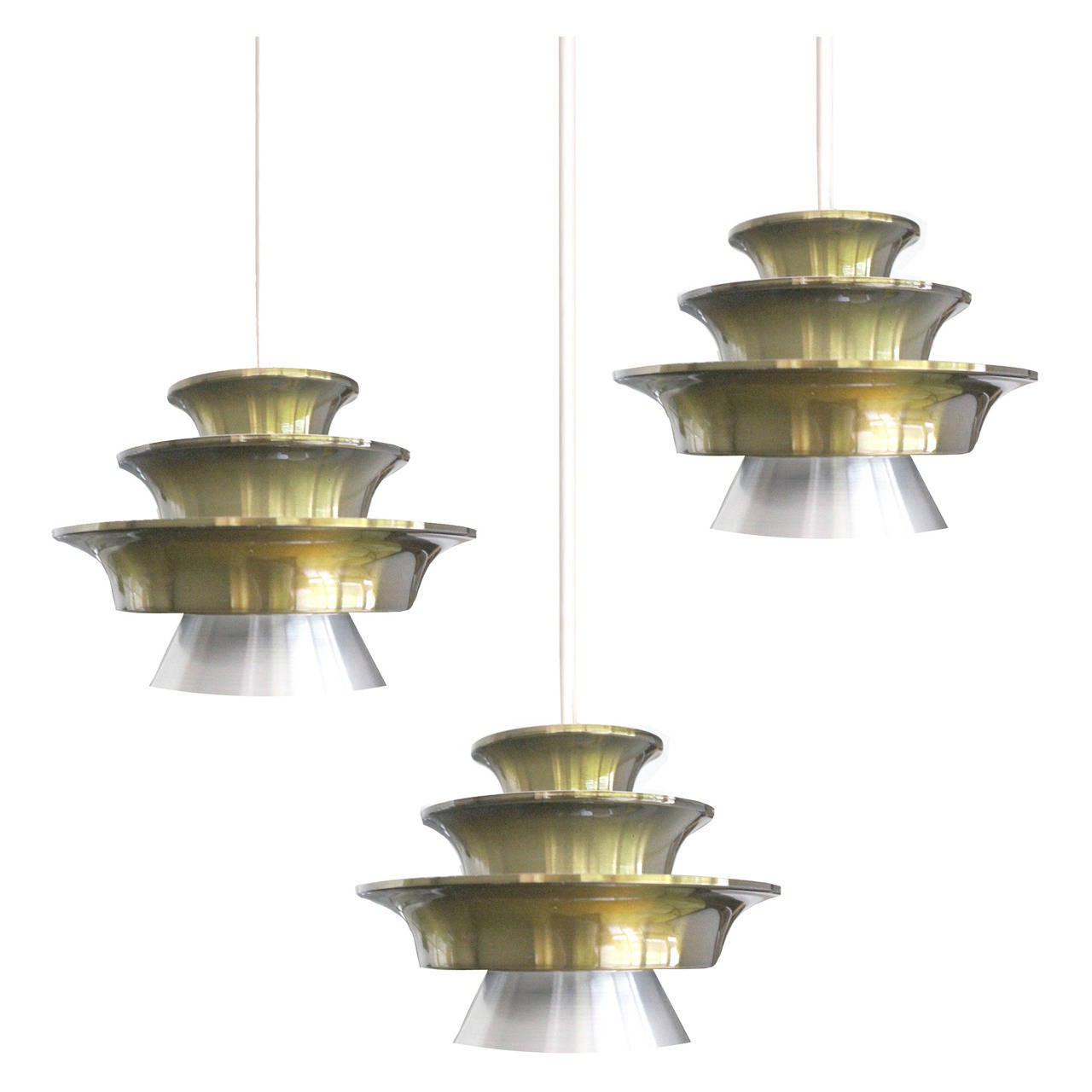 A cascade chandelier by Lyfa with 3 pendant lights, each light is made out of 4  stacked  shades, the three uppermost with a green gold varnish. 
47.24 in.H / 120 cmH (cables can be shortened)
Diameter
16.54 in. (42 cm) 
3 candelabra size bulbs, 40