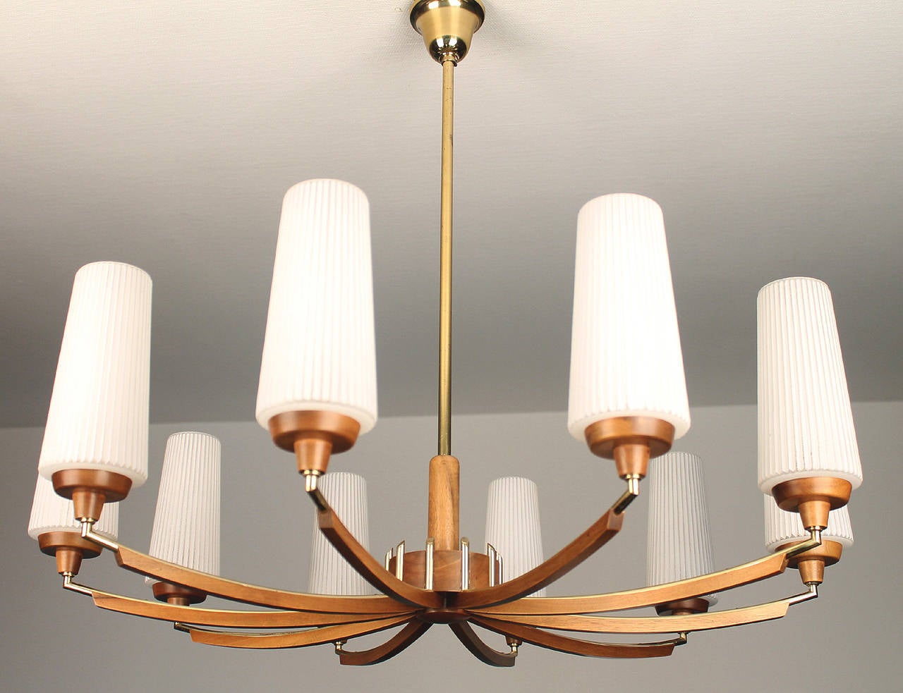 Large chandelier with wood and brass accents, fluted opaline glass shades.

Ten candelabra bulbs.


