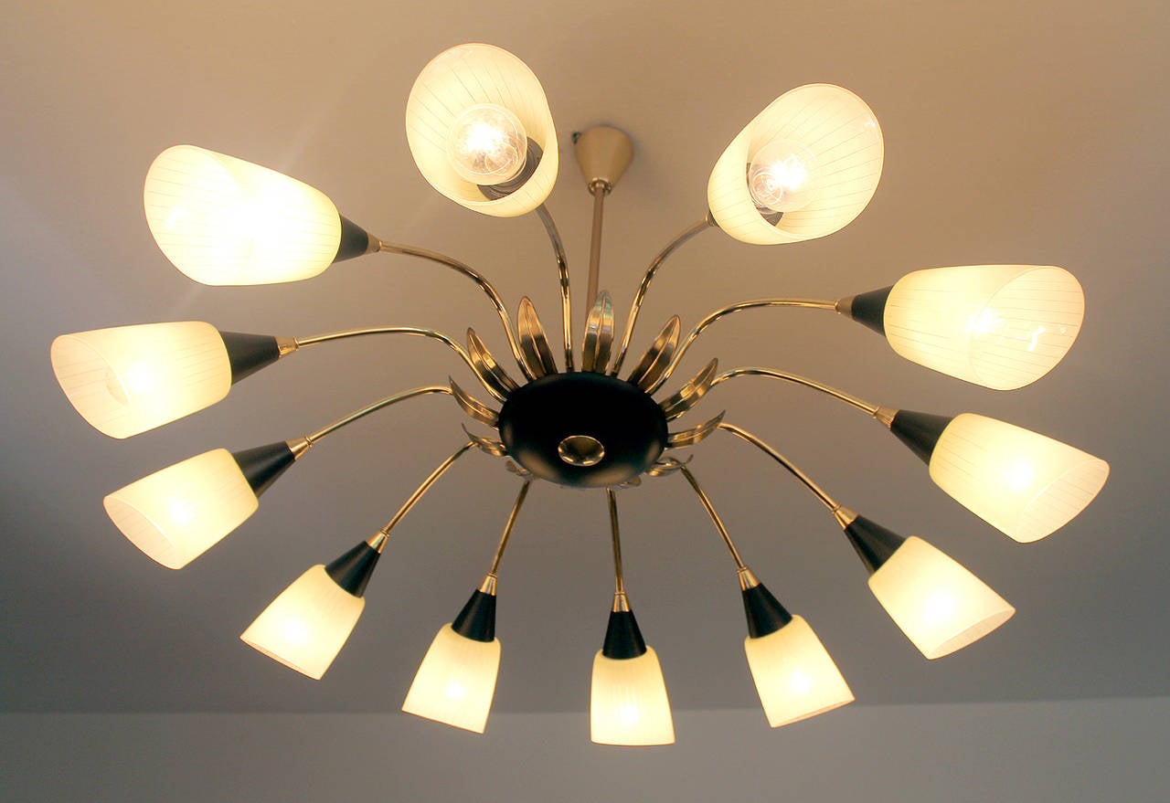 All our lights electricals are checked and tested with 110 and 220 Volts bulbs

 Very large sunburst chandelier brass and black enameled structure, glass shades with stripe patterns,

Dimensions
27.95 in.H / 71 cmH
Diameter
40.94 in. (104 cm)

12
