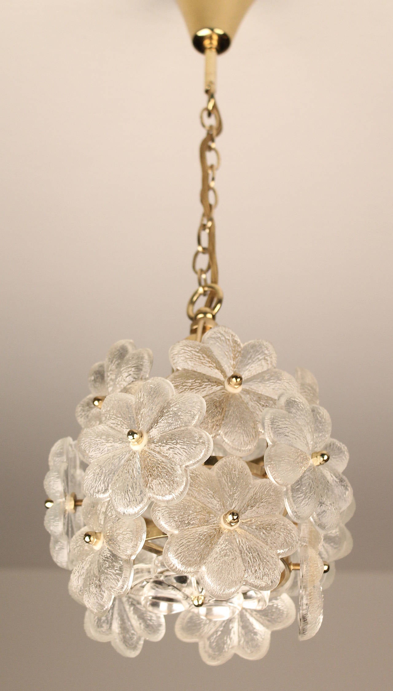 Petite Ernst Palme chandelier with glass flowers over a brass structure.

One standard size bulb up to 100 watts. run on voltage from 110 till 240 volts

height indicated is with chain, chain can be shortened.

