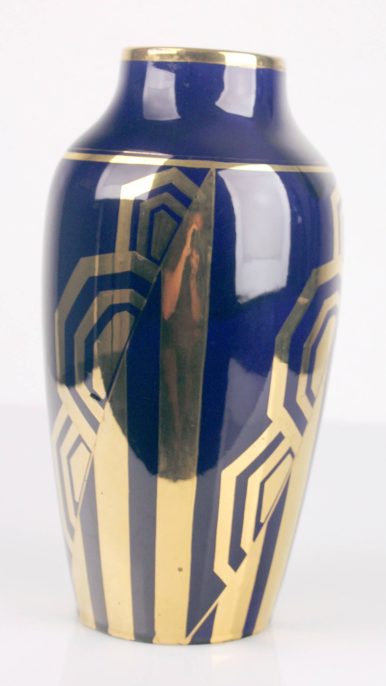 Large art deco vase manufactured by ODYV (standing for Odile BERLOT et Yvonne MUSSIER) around 1925

A typical and wonderful example of the french art deco style, it mixes elements of cubism, apparent in the gilded pattern which is repeated thrice
