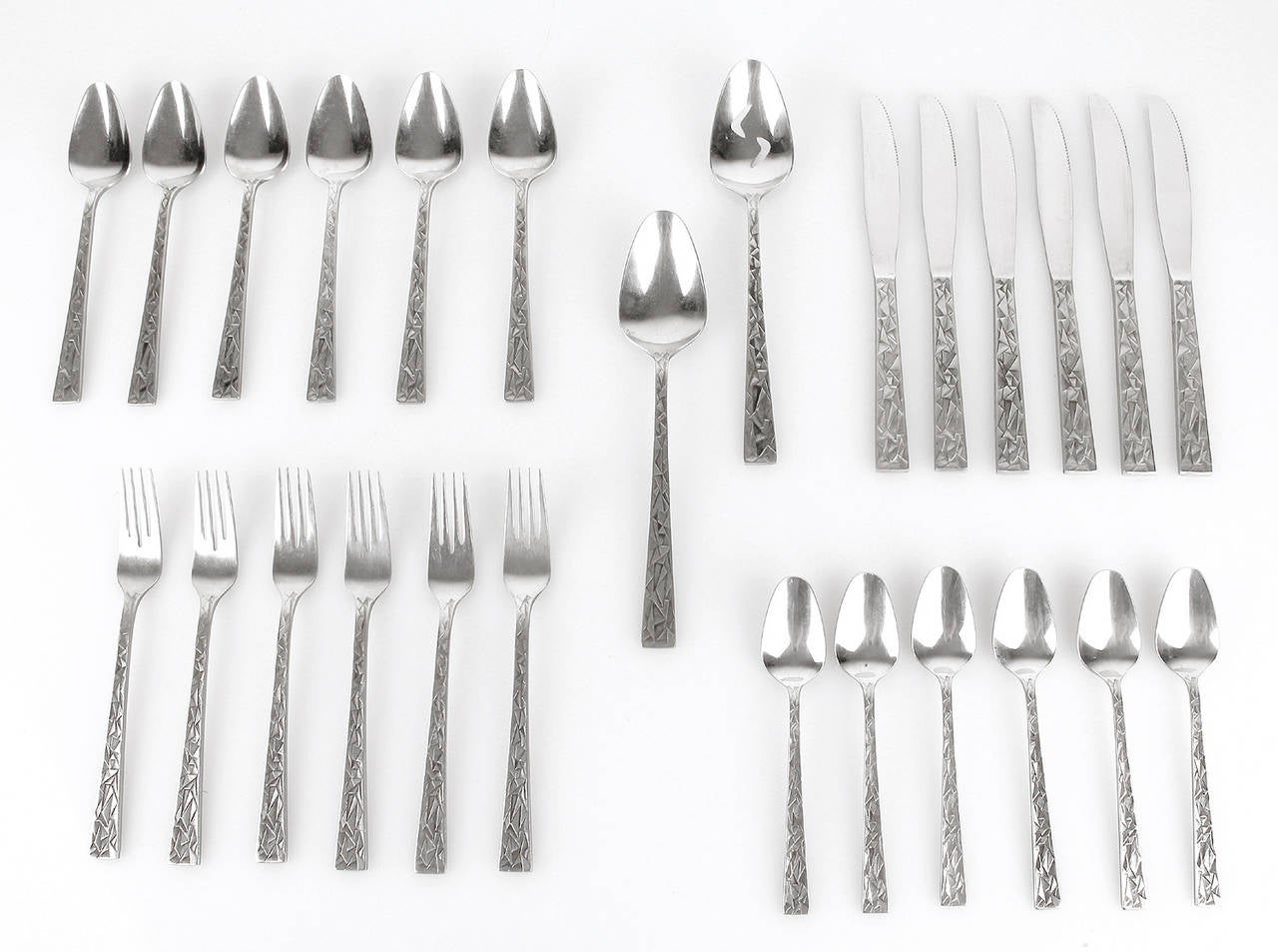 Stunning 26 piece Modernist Flatware from Japan with a brutalist sculptural pattern

Sold as a set for six persons:  Small and big forks, knives and spoons for 6 people plus a pair of salad servers.
made of stainless steel.